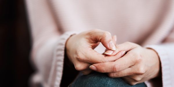 Cropped shot of a woman sitting on a sofa and feeling anxious